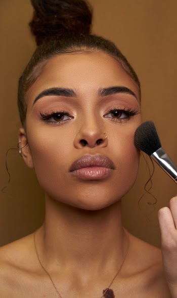 Woman Holding Makeup Brush