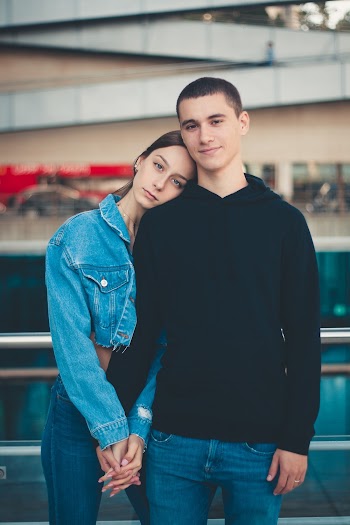 Woman Holding Man's Left Hand While Resting Her Head on Man's Shoulder