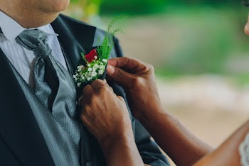 Woman Holding Man's White Boutonniere