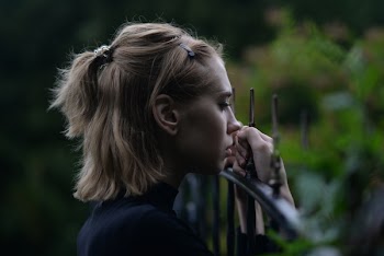 Woman Holding Metal Fence