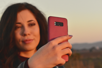 Woman Holding Midnight Black Samsung Galaxy S8+ With Red Case