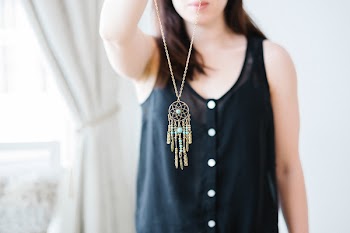 Woman Holding Necklace With Gold-colored Pendant