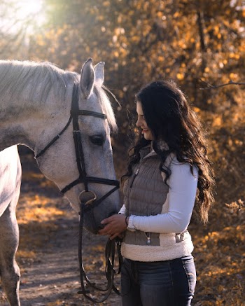 Woman Holding Nose of Horse