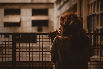 Woman Holding on Railings