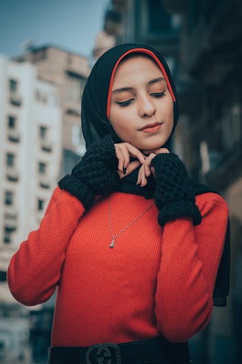 Woman Holding on to Her Headdress