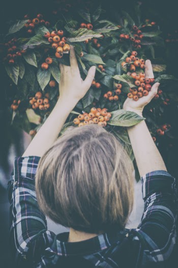 Woman Holding Orange Berries