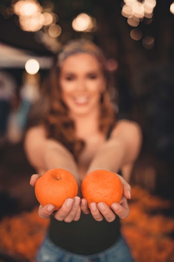 Woman Holding Orange Fruits