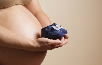 Woman Holding Pair of Toddler Blue Shoes