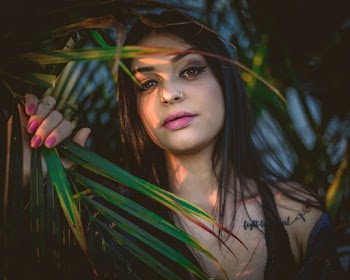 Woman Holding Palm Leaf