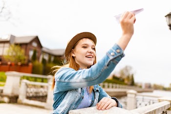 Woman Holding Paper Plane