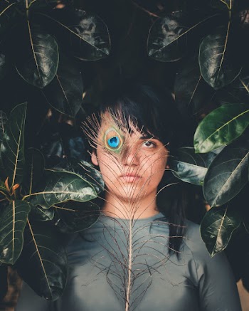 Woman Holding Peacock Feather