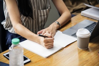 Woman Holding Pen With White Printer Paper