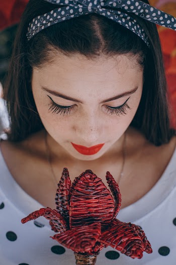 Woman Holding Petaled Flower