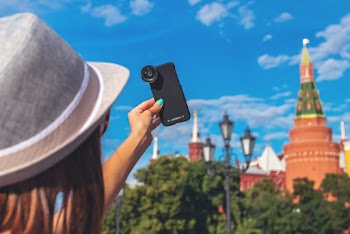 Woman Holding Phone With Camera Lens While Pointing It to the Sky