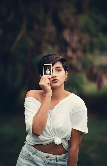 Woman Holding Photo Of Herself
