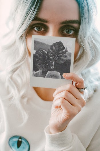 Woman Holding Photo of Leaves
