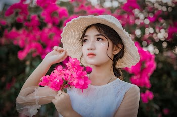 Woman Holding Pink Bougainvillea Flowers