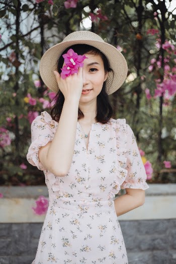 Woman Holding Pink Bougainvillea Flowers
