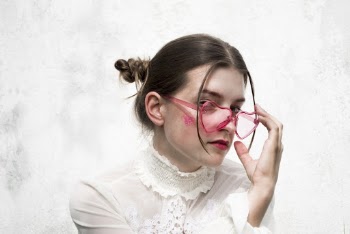 Woman Holding Pink Heart Eyeglasses