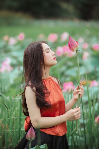 Woman Holding Pink Lotus Flower