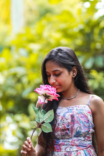 Woman Holding Pink-petaled Flower