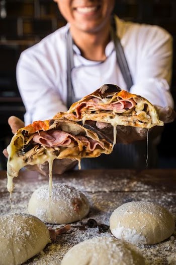 woman holding pizza