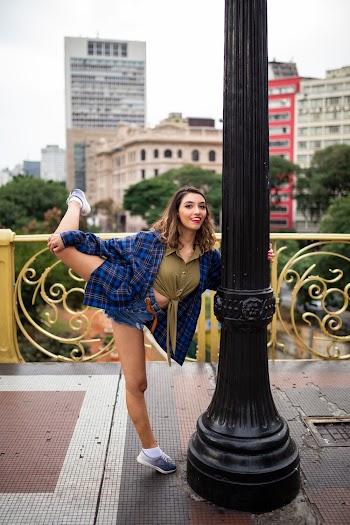 Woman Holding Post While Bending Right Leg