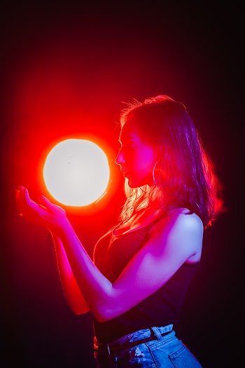 Woman Holding Powered-on Ball