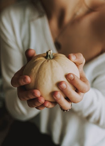 Woman Holding Pumpkin With Both Hands