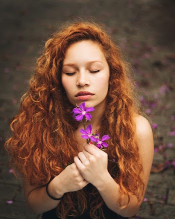 Woman Holding Purple Flowers