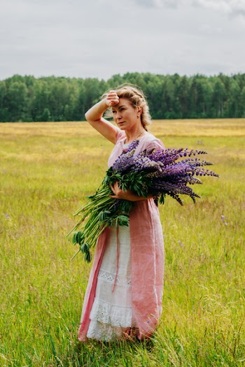 Woman Holding Purple Flowers