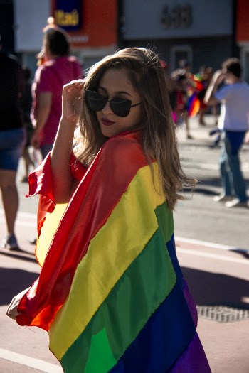 Woman Holding Rainbow Coloured Flag