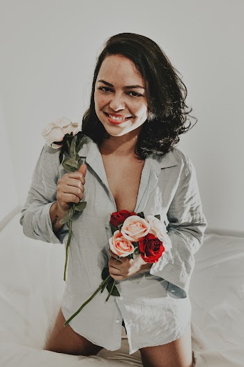 Woman Holding Red and White Petaled Flowers