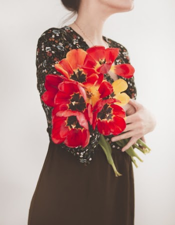 Woman Holding Red Flowers