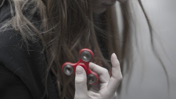 Woman Holding Red Hand Spinner