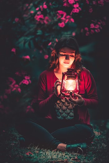 Woman Holding Red Metal Lantern