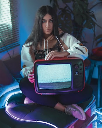 Woman Holding Red Television