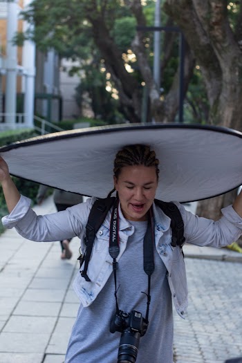 Woman Holding Round Photography Reflector On Her Head