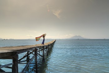 Woman Holding Shawl At The Dock