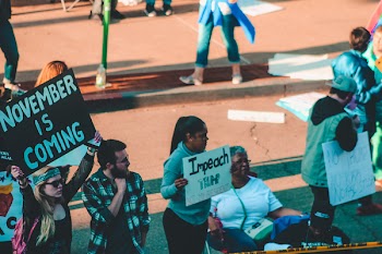 Woman Holding Sign Board With Impeach Print