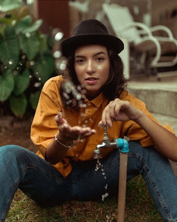 Woman Holding Silver Faucet