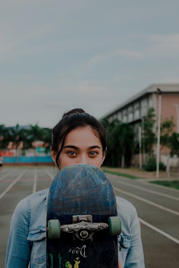 Woman Holding Skateboard