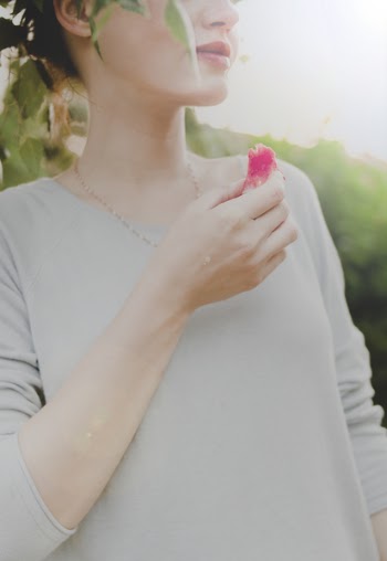 Woman Holding Sliced Fruit