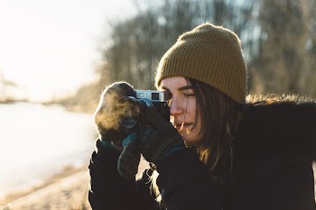 woman holding SLR camera