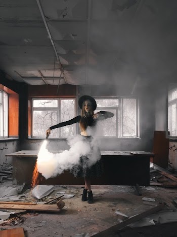 Woman Holding Smoke Flare Standing Front of Table Inside House
