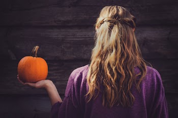 Woman Holding Squash Near Wooden Wall