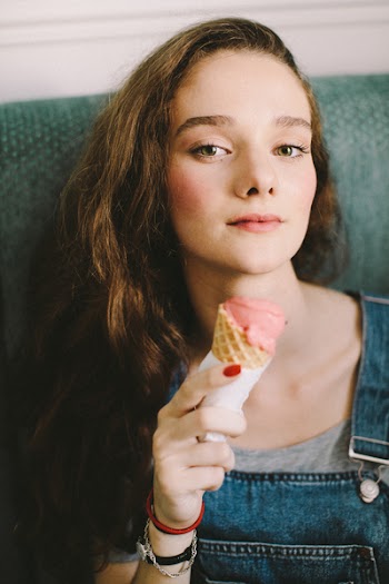 Woman Holding Strawberry Flavored Ice Cream