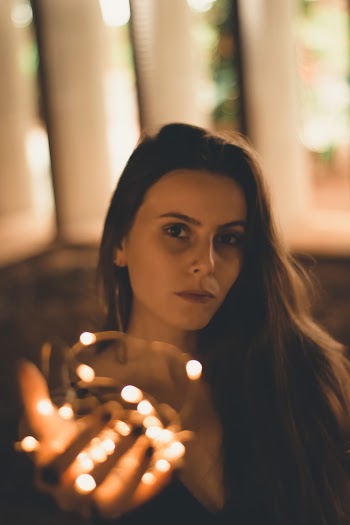 Woman Holding String Light Indoors