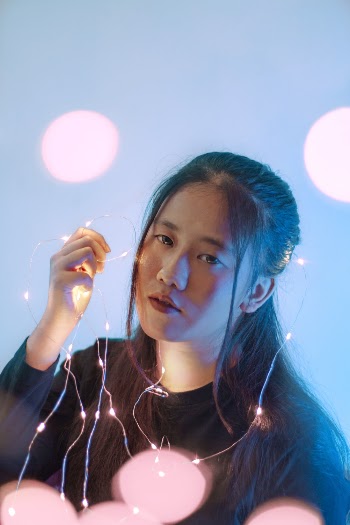 Woman Holding String Lights