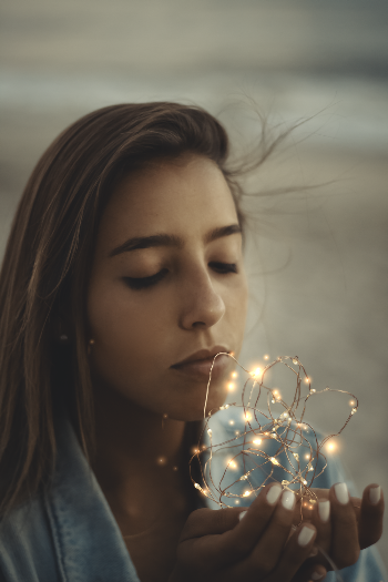 Woman Holding String Lights
